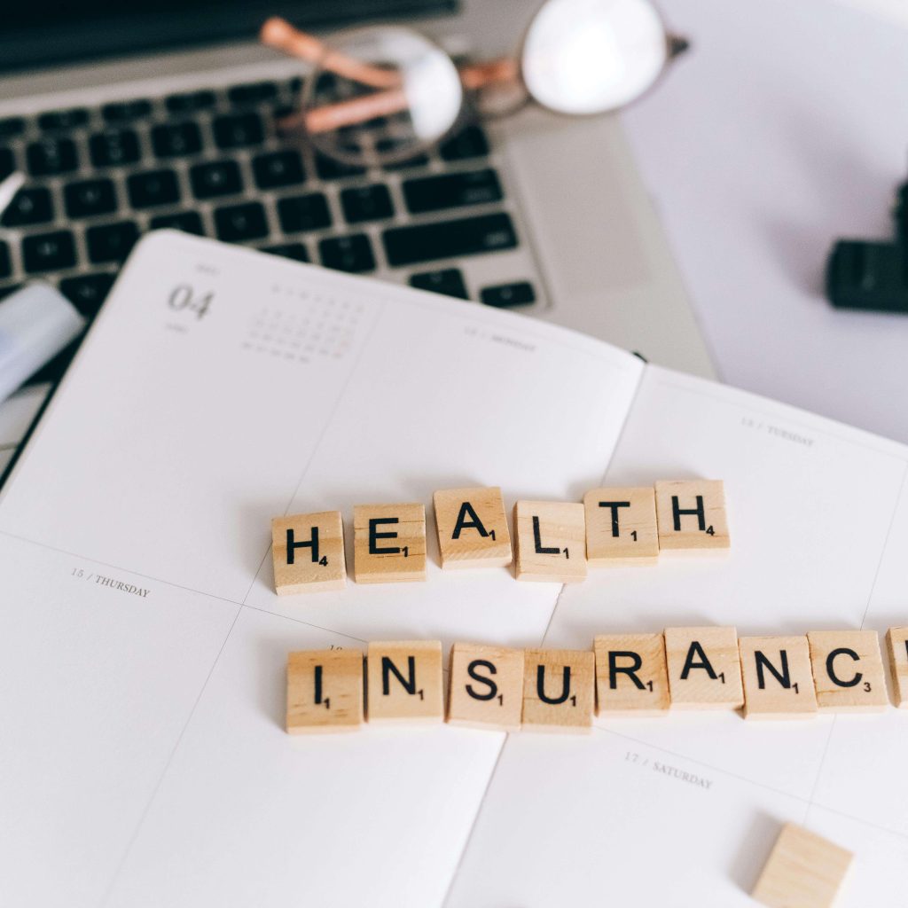 "Health insurance" on scrabble pieces on an planner. Representing how IHS offers counseling services under BCBS & Viva Health insurance. Learn more here about counseling in Alabama. 