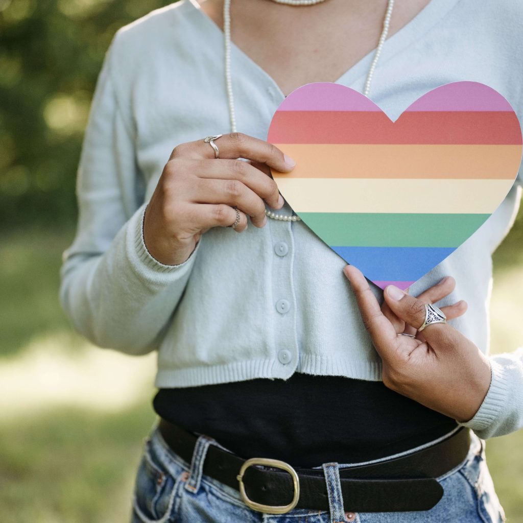 teen holding Pride heart | lgbtq affirming therapist gardendale, al | lgbtq therapy gardendale, al | lgbtq+ affirming therapy gardendale, al | gardendale, al | alabaster, al | pelham, al A teen girl holding up a Pride heart cutout. Representing how IHS therapists offer LGBTQIA+ therapy in Gardendale & throughout Alabama. Learn more here.