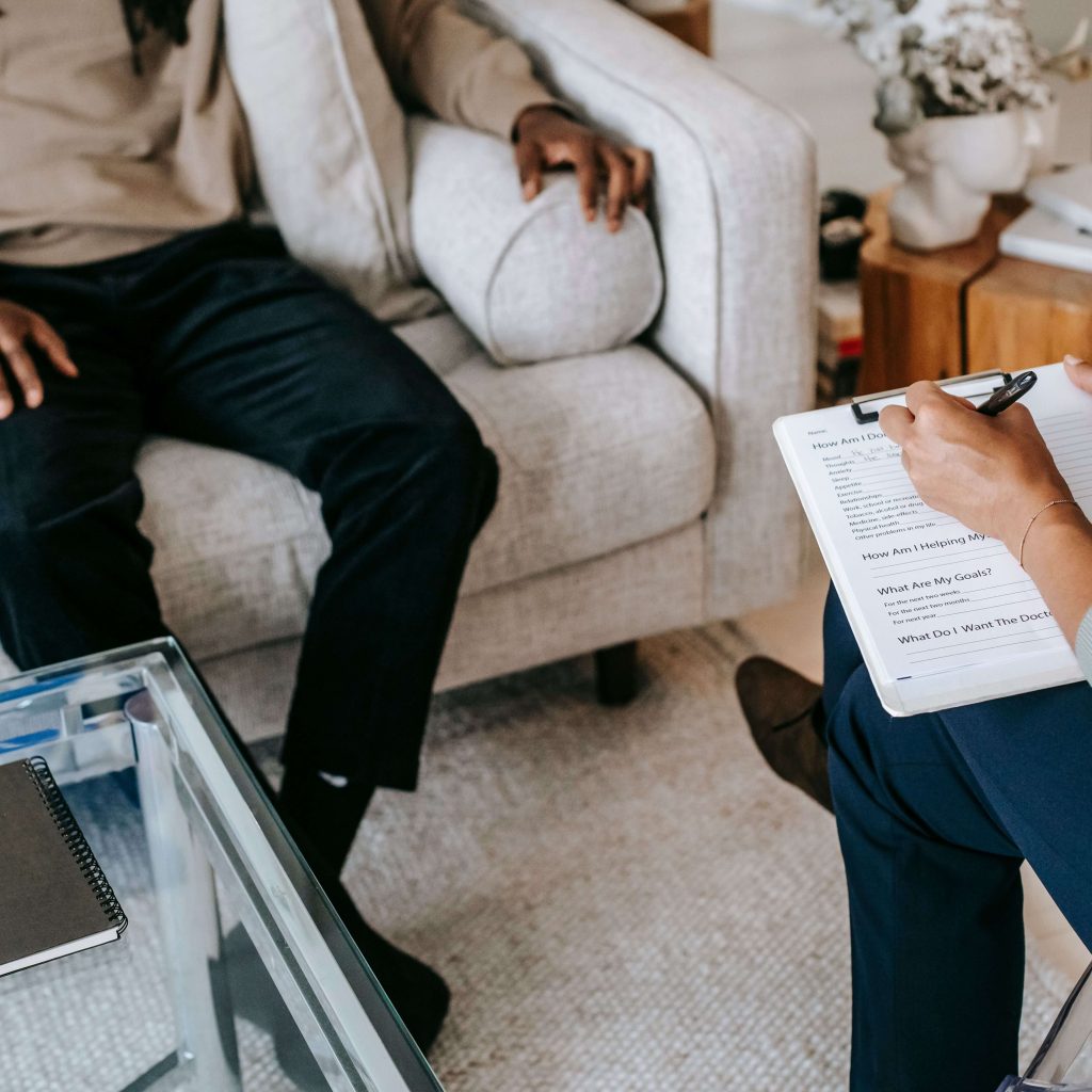 therapist talking to client | alabaster therapy | therapy in alabaster, al | counseling gardendale, al | best therapist Birmingham, al | gardendale, al | alabaster, al | pelham, al | clanton, al | calera, al A close-up of a therapist taking notes while talking to a client on the couch. Our therapists offer support for families, children & adults with personalized therapy in Alabaster, AL. Learn more here.